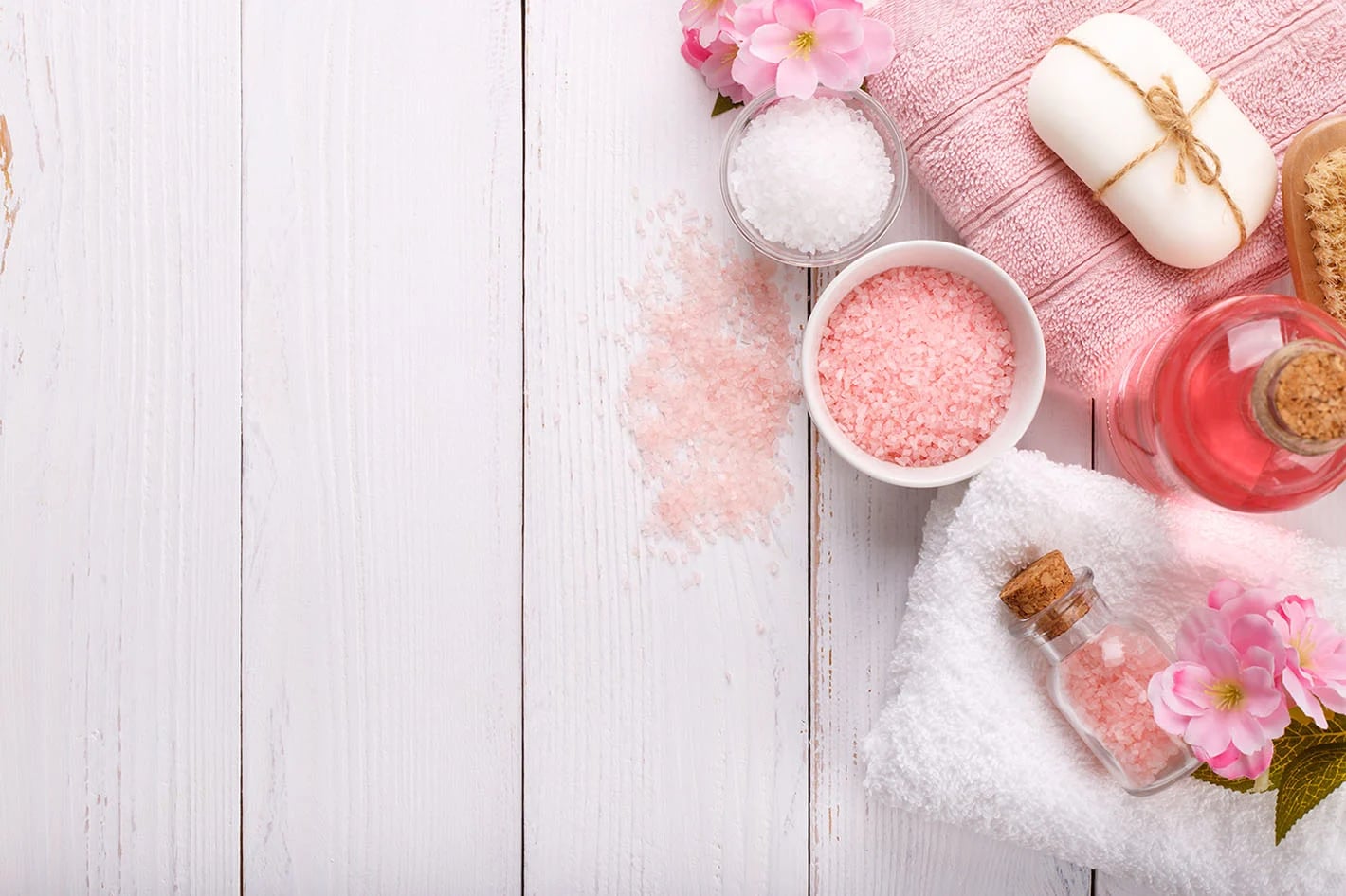 Pink flowers, soft towels, and spa care essentials